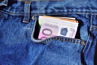 Banknotes sticking out of a jeans pocket